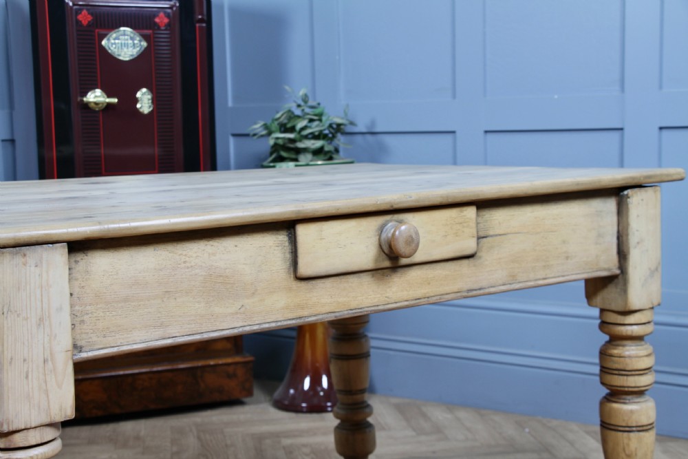 A restored Victorian pine kitchen table featuring a scrubbed rectangular plank top, a single frieze drawer with a wooden knob, and four turned legs. View V