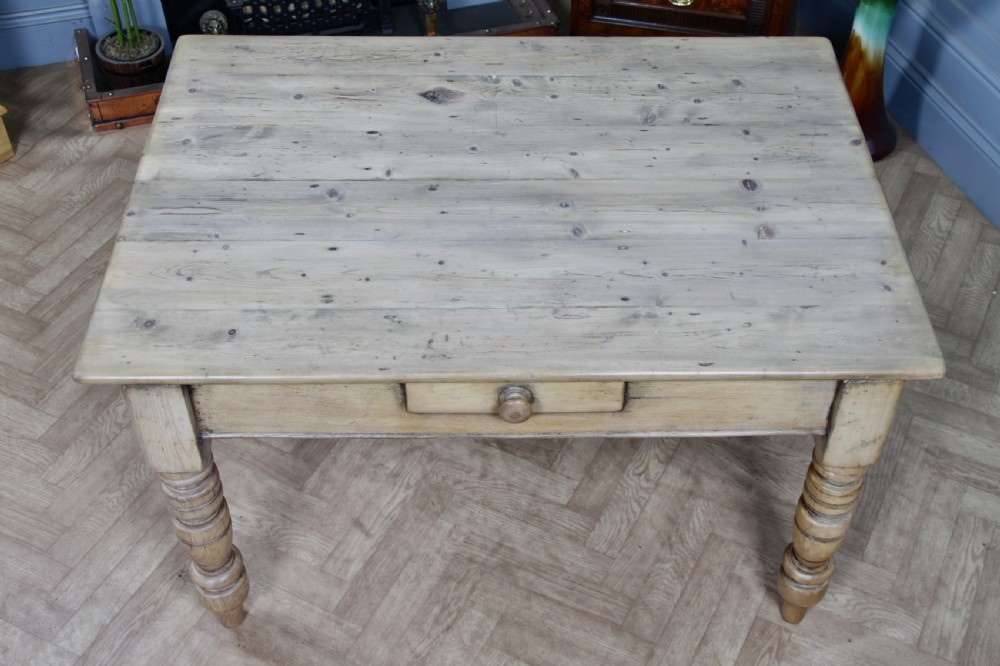 A restored Victorian pine kitchen table featuring a scrubbed rectangular plank top, a single frieze drawer with a wooden knob, and four turned legs. View VI