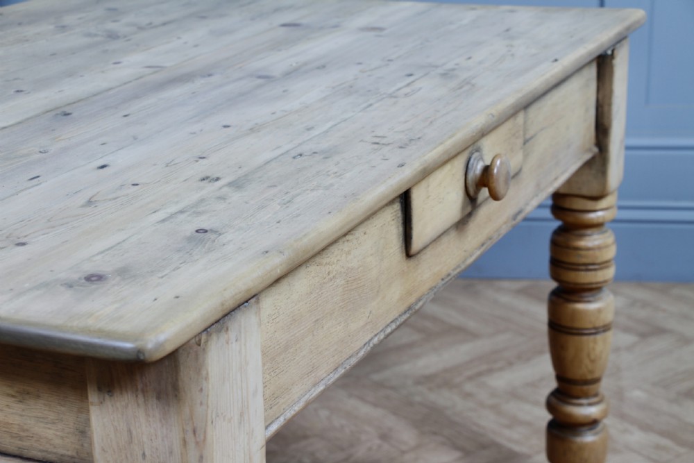 A restored Victorian pine kitchen table featuring a scrubbed rectangular plank top, a single frieze drawer with a wooden knob, and four turned legs. View VIII