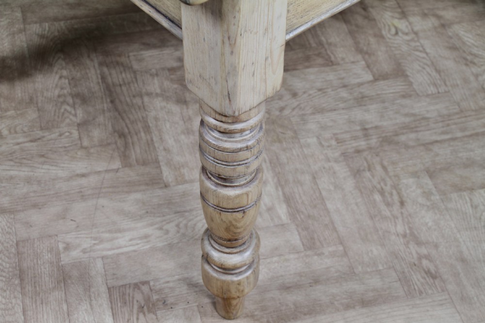 A restored Victorian pine kitchen table featuring a scrubbed rectangular plank top, a single frieze drawer with a wooden knob, and four turned legs. View IX