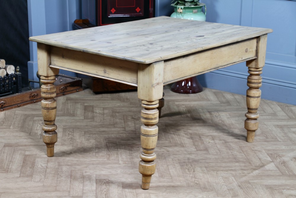 A restored Victorian pine kitchen table featuring a scrubbed rectangular plank top, a single frieze drawer with a wooden knob, and four turned legs. View XII