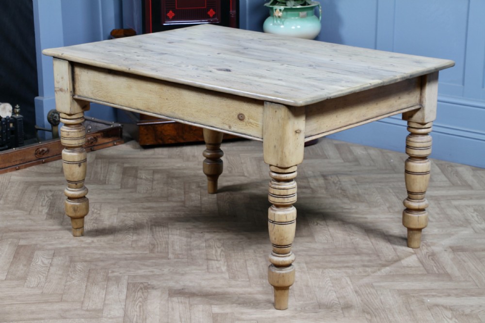 A restored Victorian pine kitchen table featuring a scrubbed rectangular plank top, a single frieze drawer with a wooden knob, and four turned legs. View XIII