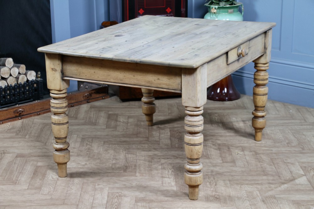 A restored Victorian pine kitchen table featuring a scrubbed rectangular plank top, a single frieze drawer with a wooden knob, and four turned legs. View XIV