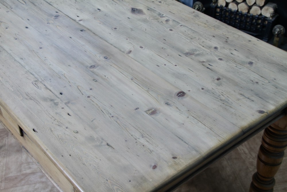 A restored Victorian pine kitchen table featuring a scrubbed rectangular plank top, a single frieze drawer with a wooden knob, and four turned legs. View XV