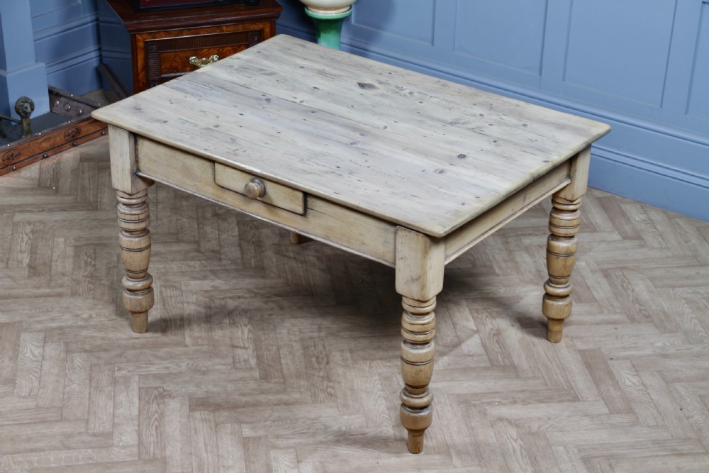 A restored Victorian pine kitchen table featuring a scrubbed rectangular plank top, a single frieze drawer with a wooden knob, and four turned legs. View XVIII