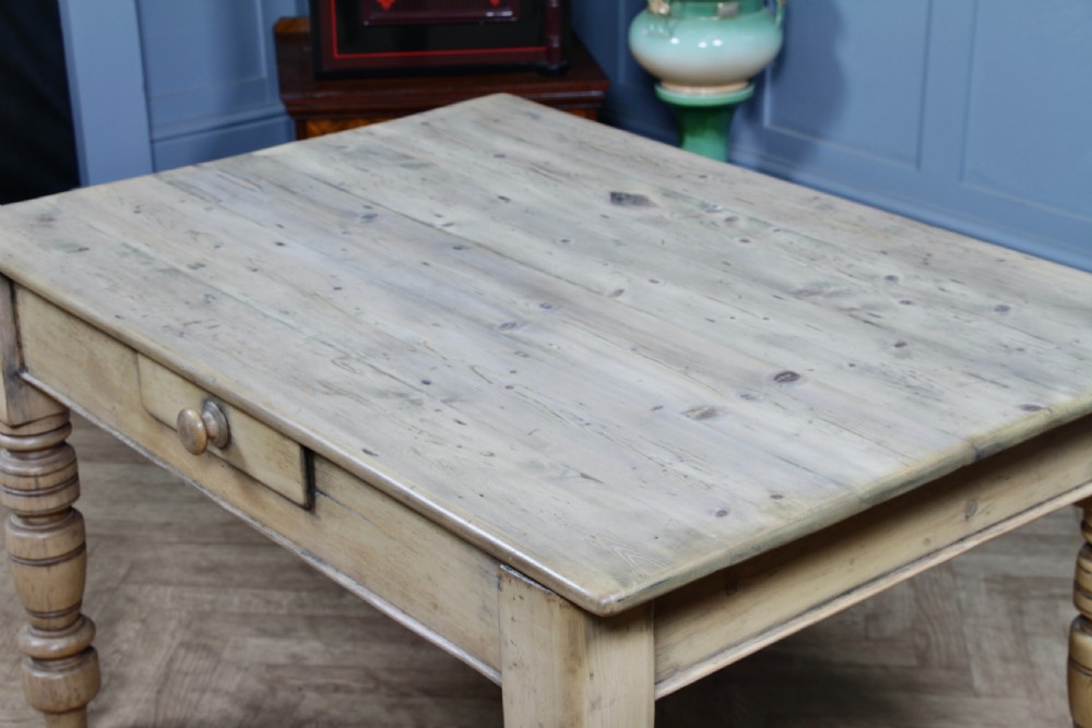 A restored Victorian pine kitchen table featuring a scrubbed rectangular plank top, a single frieze drawer with a wooden knob, and four turned legs. View XIX