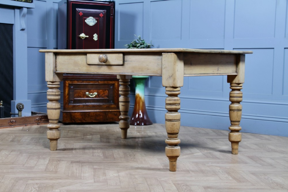 A restored Victorian pine kitchen table featuring a scrubbed rectangular plank top, a single frieze drawer with a wooden knob, and four turned legs. View XX