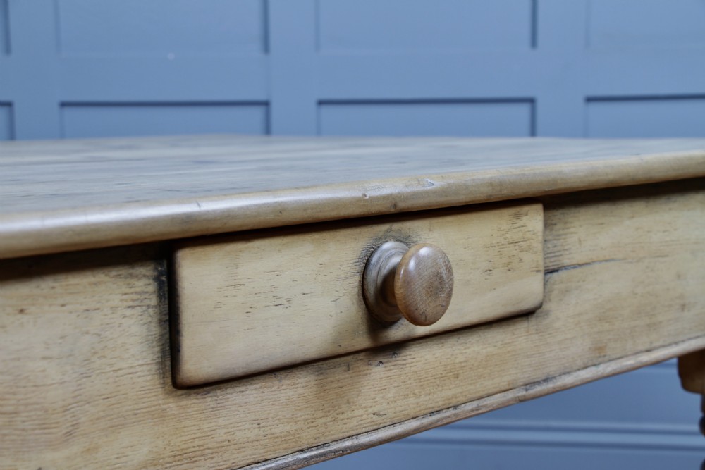 A restored Victorian pine kitchen table featuring a scrubbed rectangular plank top, a single frieze drawer with a wooden knob, and four turned legs. View XXI