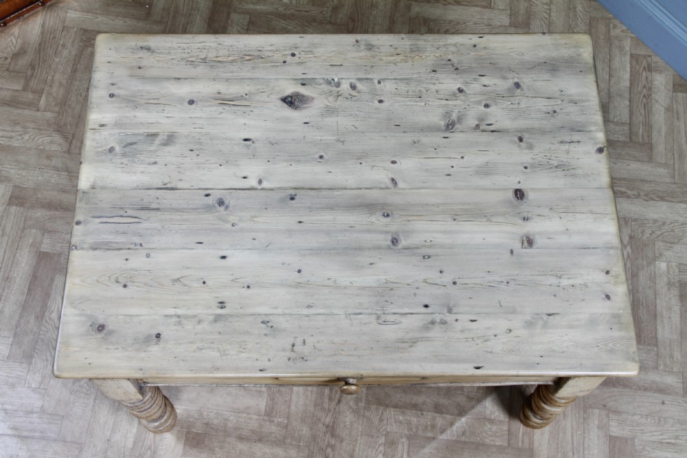A restored Victorian pine kitchen table featuring a scrubbed rectangular plank top, a single frieze drawer with a wooden knob, and four turned legs. View XXII