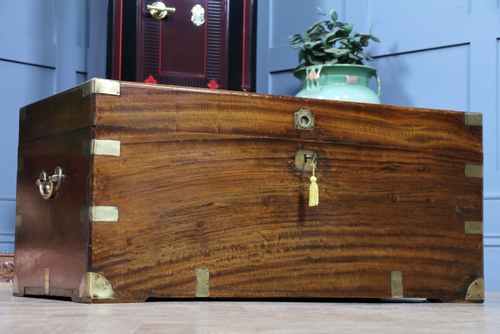A rectangular Victorian camphor wood military campaign trunk featuring brass corner straps, side handles, and a central brass keyhole. View II