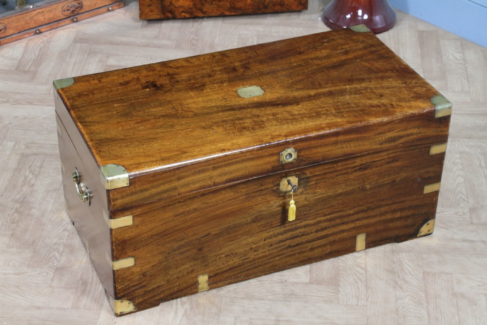 A rectangular Victorian camphor wood military campaign trunk featuring brass corner straps, side handles, and a central brass keyhole. View IV