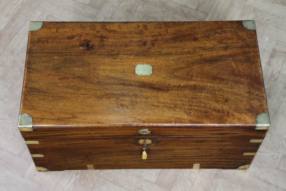 A rectangular Victorian camphor wood military campaign trunk featuring brass corner straps, side handles, and a central brass keyhole. View VI