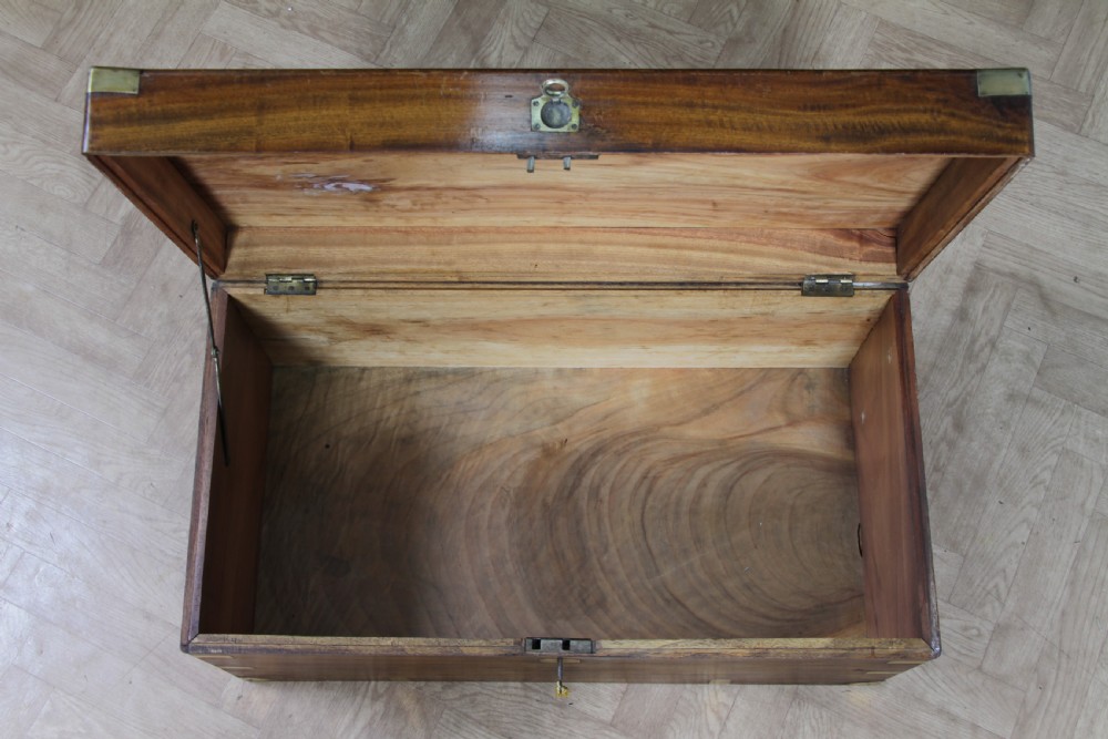 A rectangular Victorian camphor wood military campaign trunk featuring brass corner straps, side handles, and a central brass keyhole. View VIII
