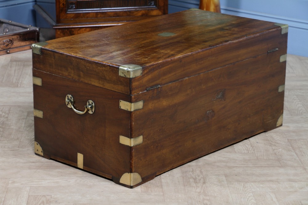 A rectangular Victorian camphor wood military campaign trunk featuring brass corner straps, side handles, and a central brass keyhole. View XVII