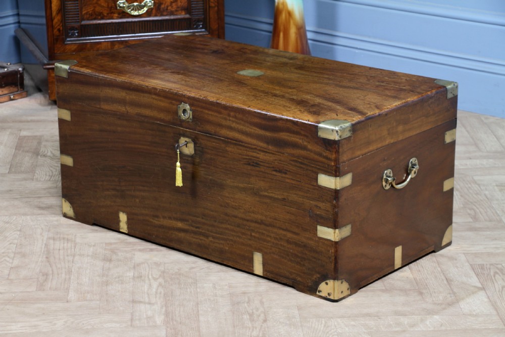 A rectangular Victorian camphor wood military campaign trunk featuring brass corner straps, side handles, and a central brass keyhole. View XVIII