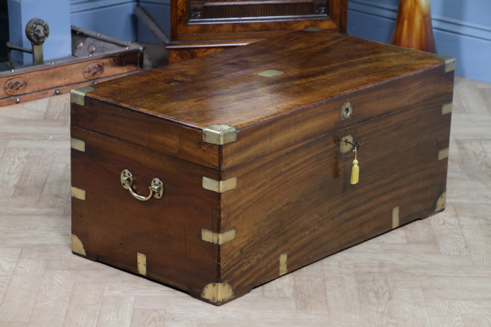 A rectangular Victorian camphor wood military campaign trunk featuring brass corner straps, side handles, and a central brass keyhole. View XX