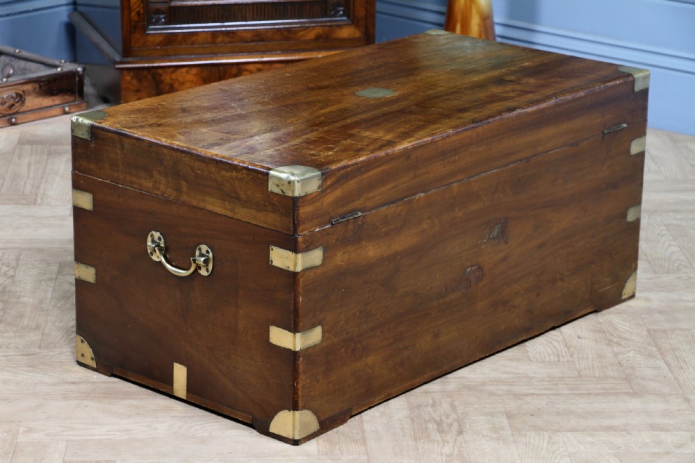 A rectangular Victorian camphor wood military campaign trunk featuring brass corner straps, side handles, and a central brass keyhole. View XXI