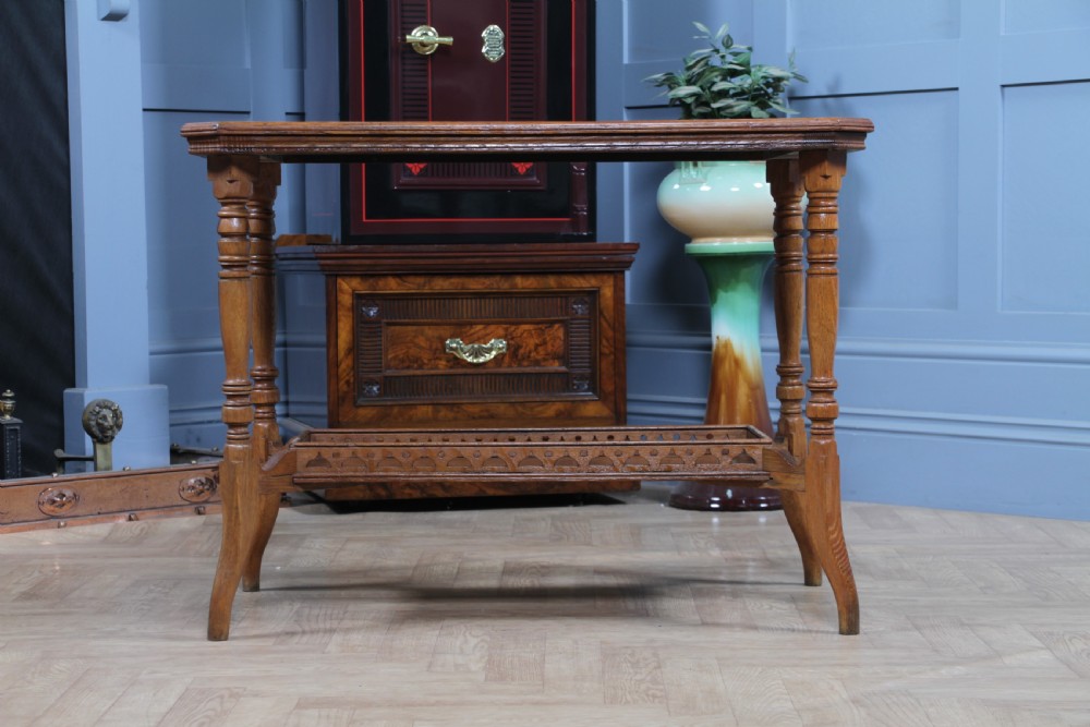 An Edwardian golden oak side table featuring a rectangular top, turned support legs, and a lower undertier shelf with a pierced cut-out gallery rail. View XIX