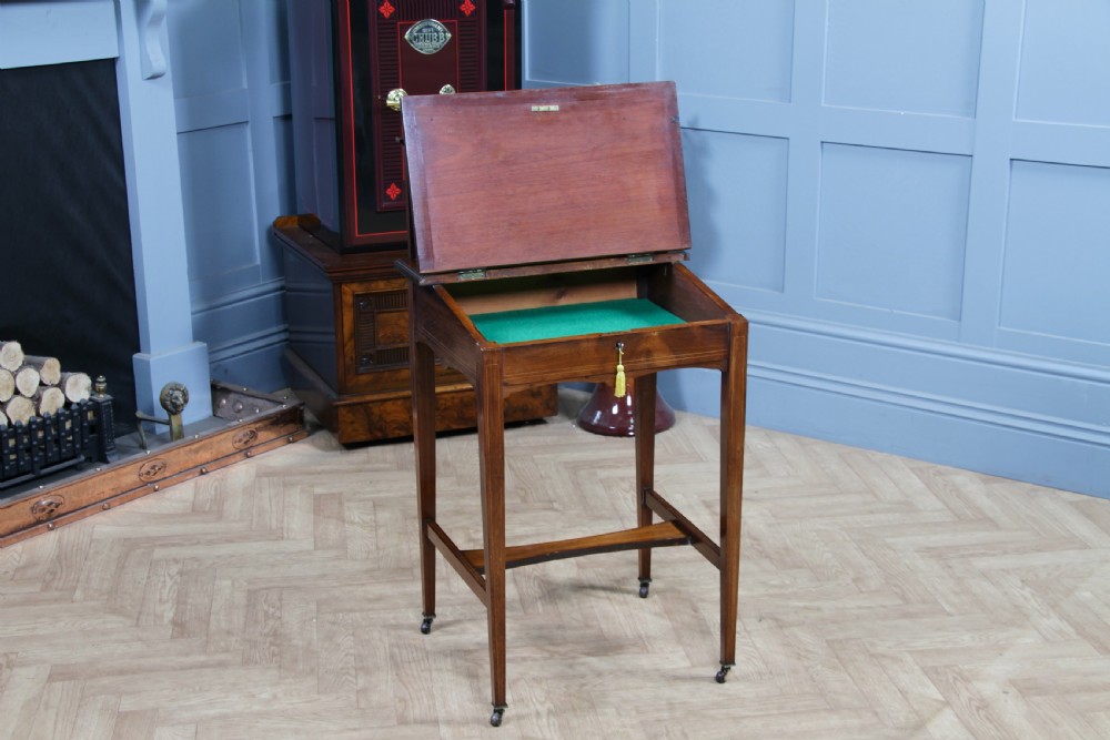 A late Victorian inlaid rosewood bonheur du jour writing desk featuring a green leather surface, raised gallery shelf, and tapered legs with brass castors. View III