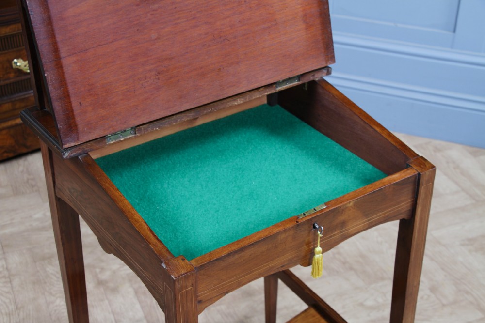 A late Victorian inlaid rosewood bonheur du jour writing desk featuring a green leather surface, raised gallery shelf, and tapered legs with brass castors. View XI