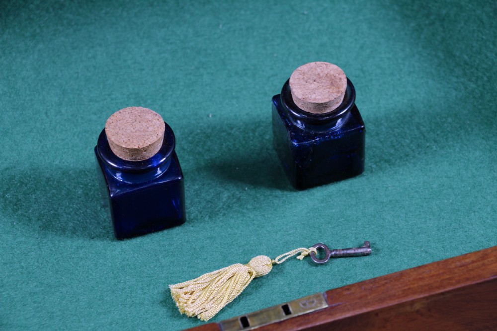 A late Victorian inlaid rosewood bonheur du jour writing desk featuring a green leather surface, raised gallery shelf, and tapered legs with brass castors. View XII