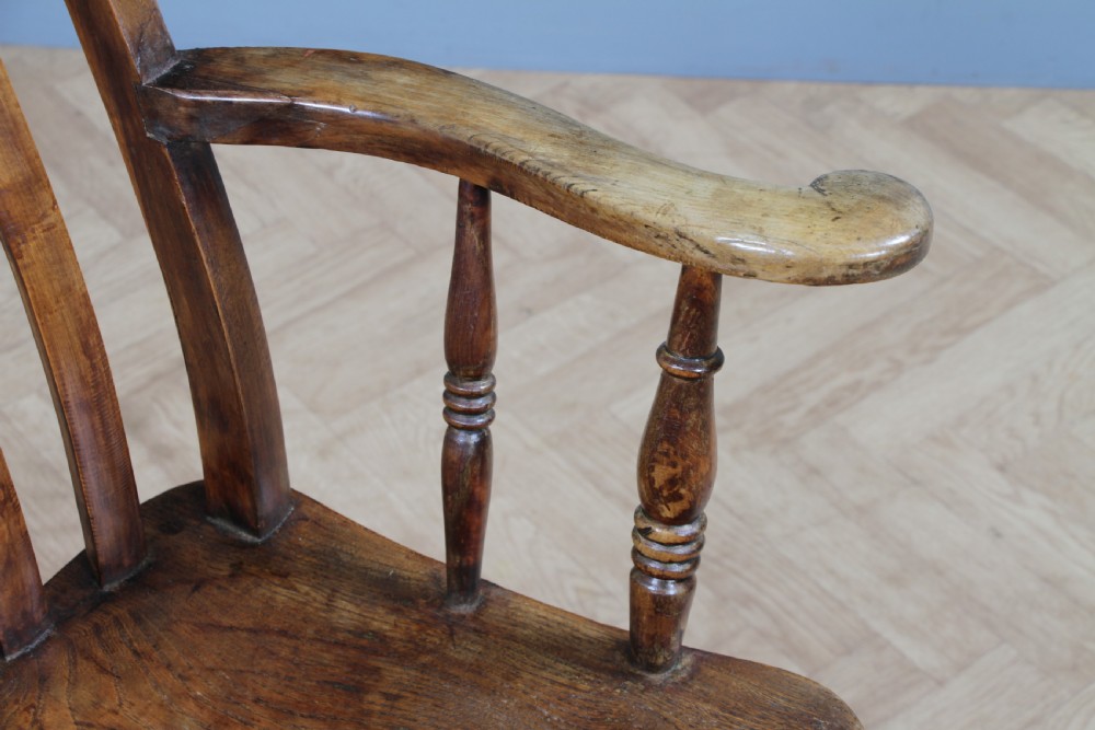 An antique Victorian lathe back armchair crafted from warm brown timber with turned legs and a solid shaped seat. View VIII