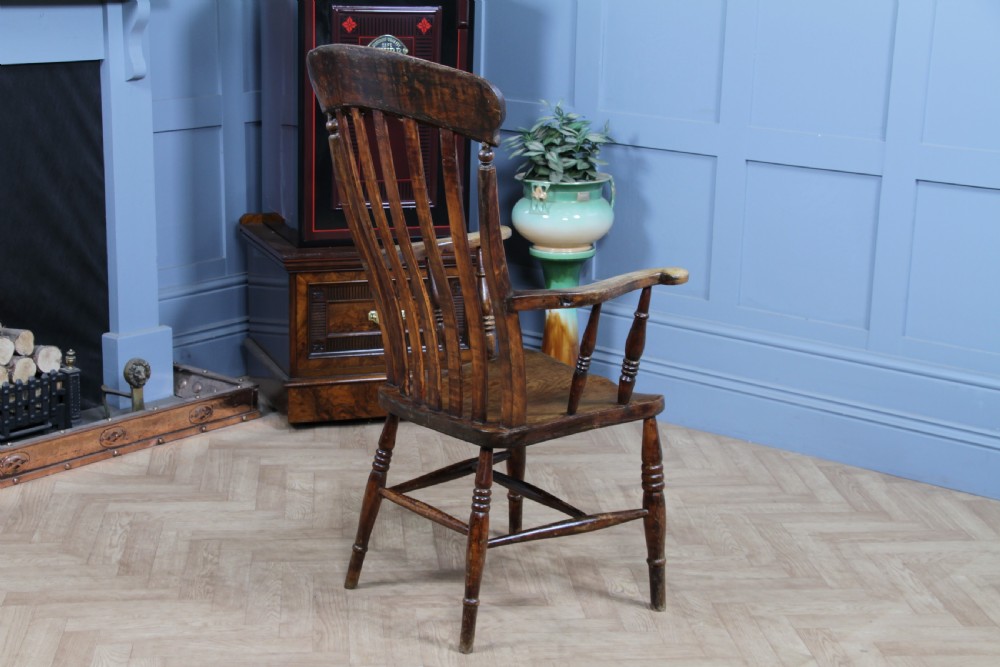 An antique Victorian lathe back armchair crafted from warm brown timber with turned legs and a solid shaped seat. View XI