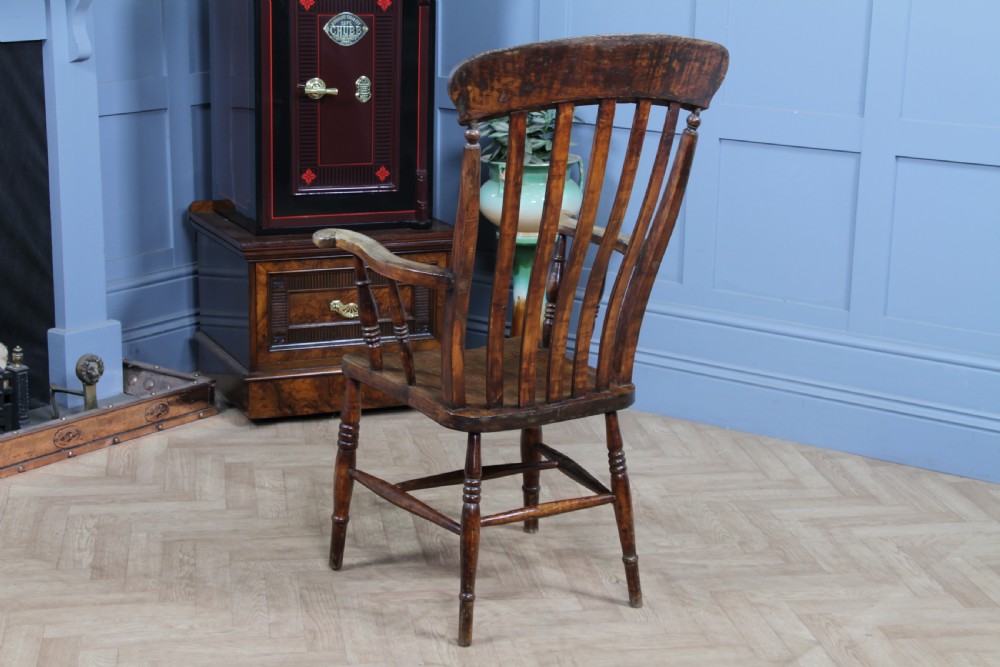 An antique Victorian lathe back armchair crafted from warm brown timber with turned legs and a solid shaped seat. View XII