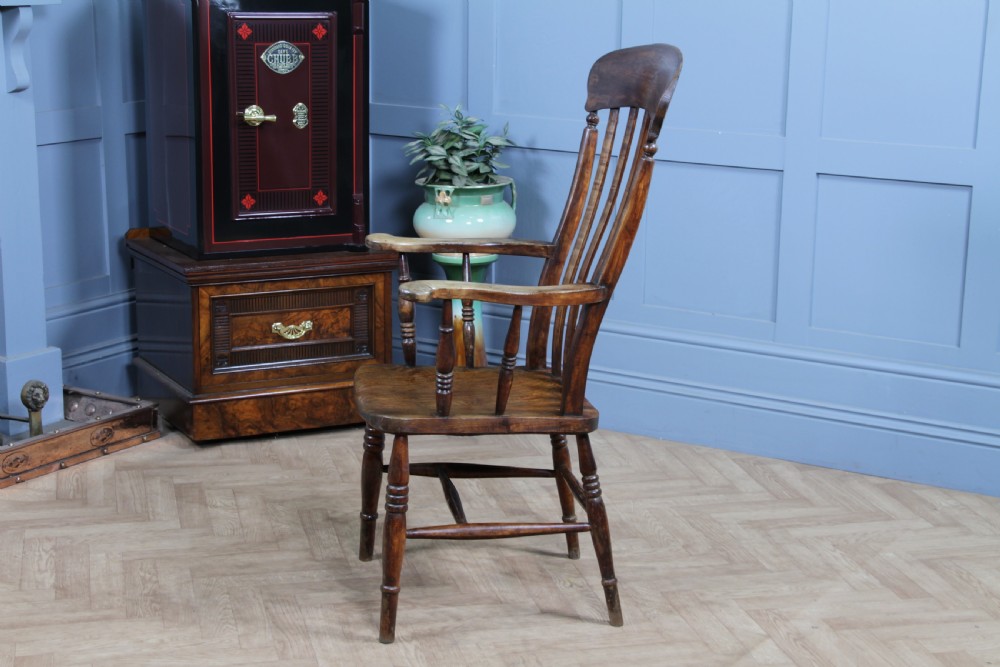 An antique Victorian lathe back armchair crafted from warm brown timber with turned legs and a solid shaped seat. View XIII