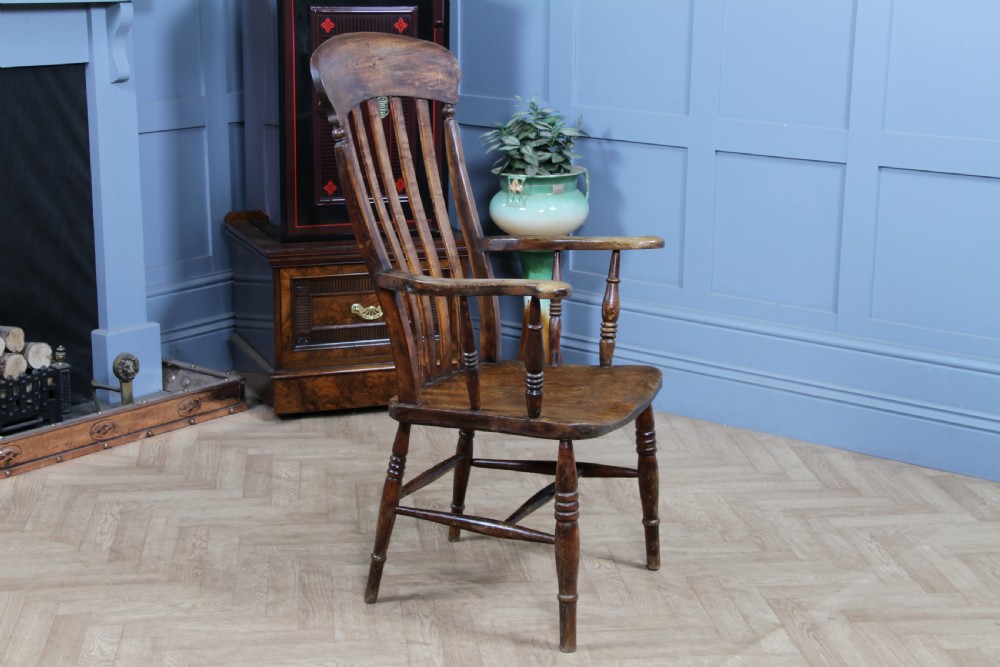 An antique Victorian lathe back armchair crafted from warm brown timber with turned legs and a solid shaped seat. View XIV