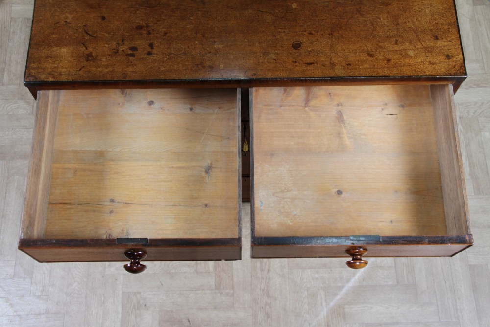 A restored Georgian mahogany chest of five drawers featuring two short drawers over three long drawers with turned wooden knobs and bracket feet. View XV