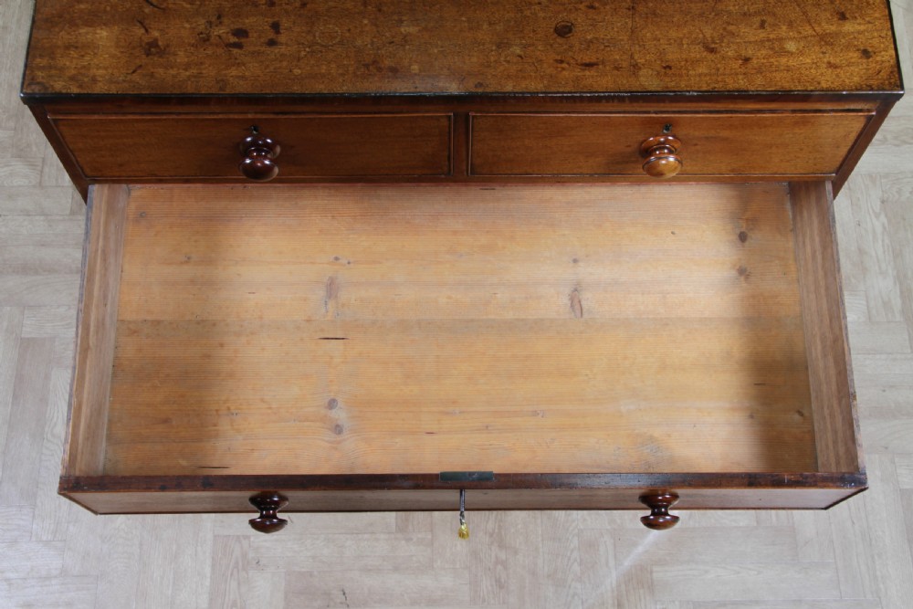 A restored Georgian mahogany chest of five drawers featuring two short drawers over three long drawers with turned wooden knobs and bracket feet. View XVI