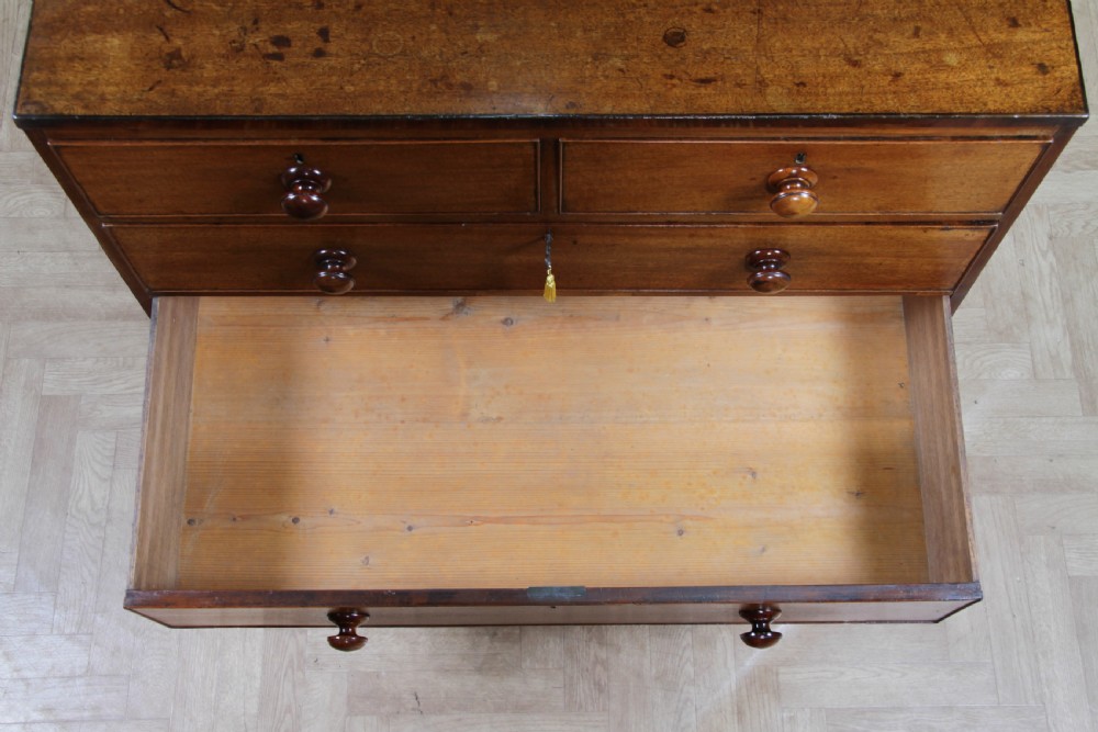 A restored Georgian mahogany chest of five drawers featuring two short drawers over three long drawers with turned wooden knobs and bracket feet. View XVII