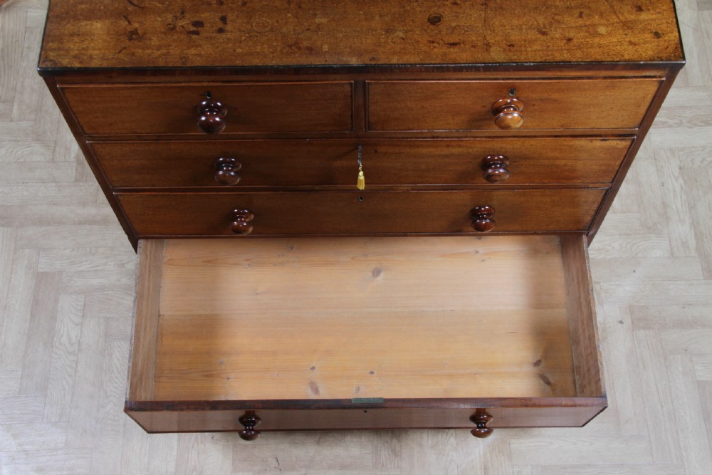 A restored Georgian mahogany chest of five drawers featuring two short drawers over three long drawers with turned wooden knobs and bracket feet. View XVIII