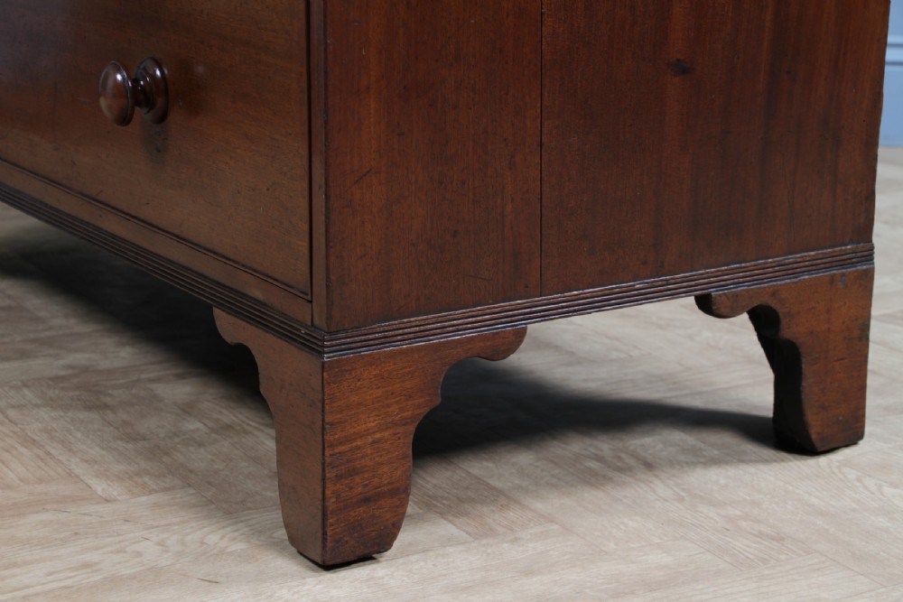 A restored Georgian mahogany chest of five drawers featuring two short drawers over three long drawers with turned wooden knobs and bracket feet. View XIX