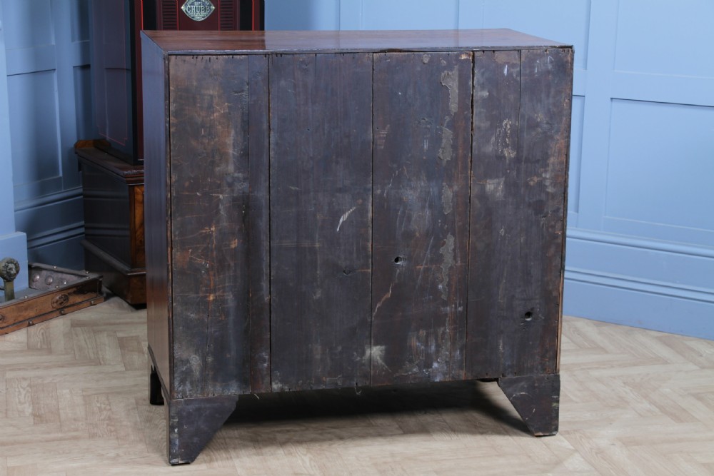 A restored Georgian mahogany chest of five drawers featuring two short drawers over three long drawers with turned wooden knobs and bracket feet. View XX