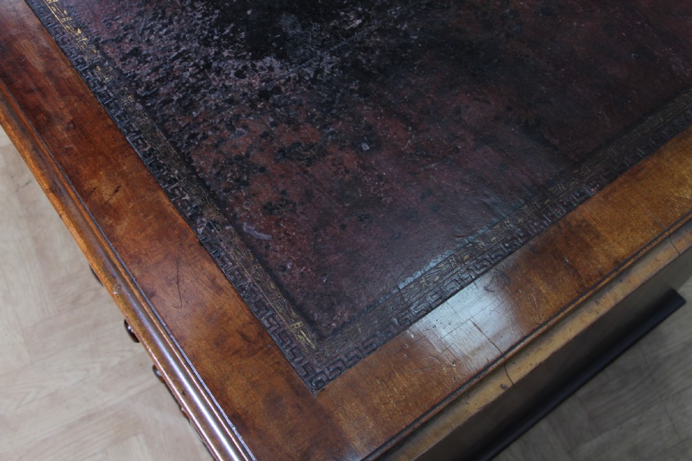 A Victorian mahogany pedestal desk featuring twin drawer pedestals, a dark leather writing inset, and a matching angled writing slope. View IX