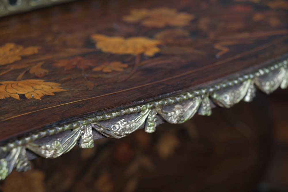 A French Napoleon III rosewood tabletop etagere featuring two tiered shelves decorated with floral marquetry, gilt metal mounts, a gallery rail, and two small base drawers. View VI