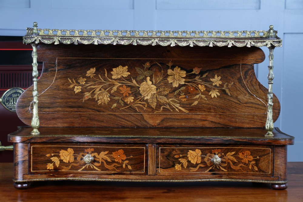 A French Napoleon III rosewood tabletop etagere featuring two tiered shelves decorated with floral marquetry, gilt metal mounts, a gallery rail, and two small base drawers. View VIII