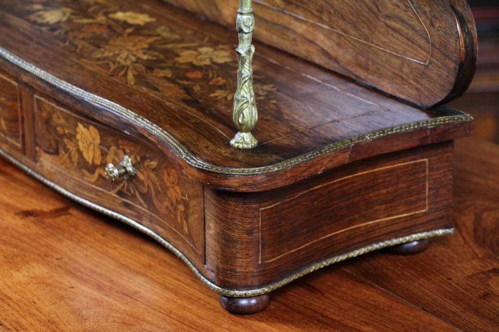 A French Napoleon III rosewood tabletop etagere featuring two tiered shelves decorated with floral marquetry, gilt metal mounts, a gallery rail, and two small base drawers. View X