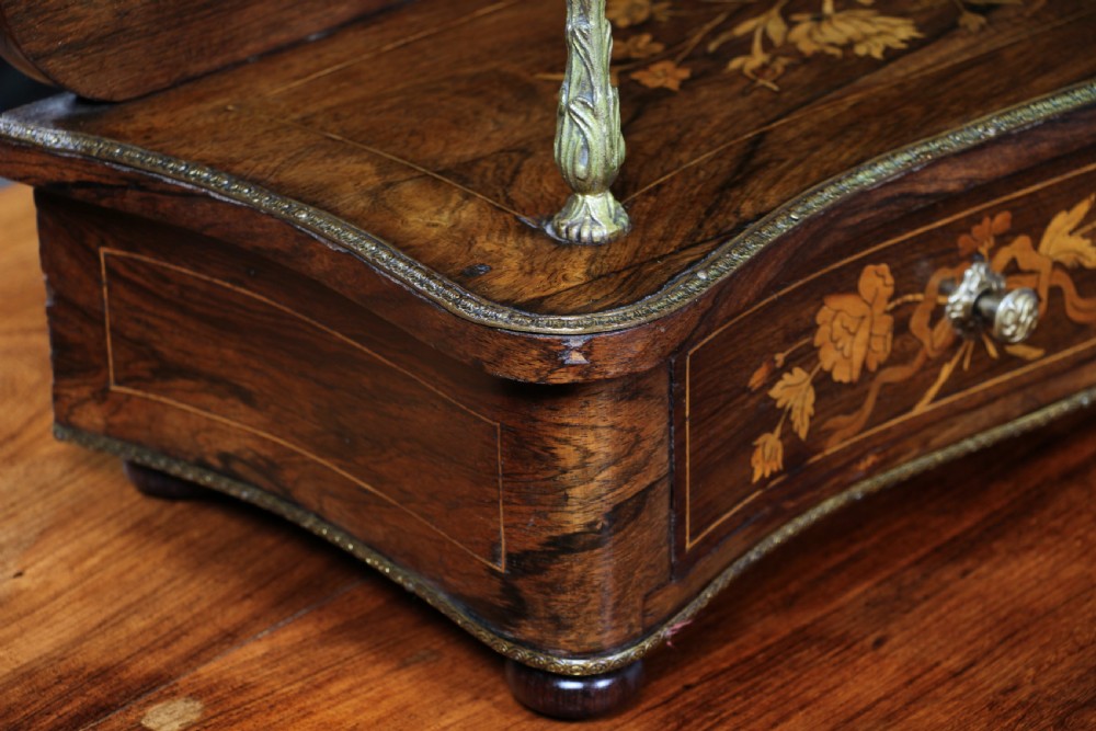 A French Napoleon III rosewood tabletop etagere featuring two tiered shelves decorated with floral marquetry, gilt metal mounts, a gallery rail, and two small base drawers. View XI