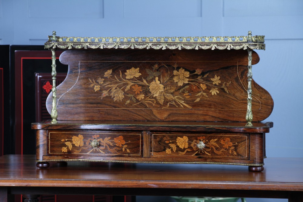 A French Napoleon III rosewood tabletop etagere featuring two tiered shelves decorated with floral marquetry, gilt metal mounts, a gallery rail, and two small base drawers. View XII