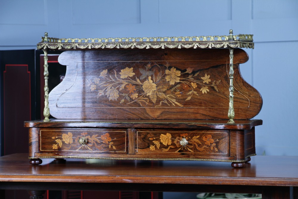 A French Napoleon III rosewood tabletop etagere featuring two tiered shelves decorated with floral marquetry, gilt metal mounts, a gallery rail, and two small base drawers. View XIII