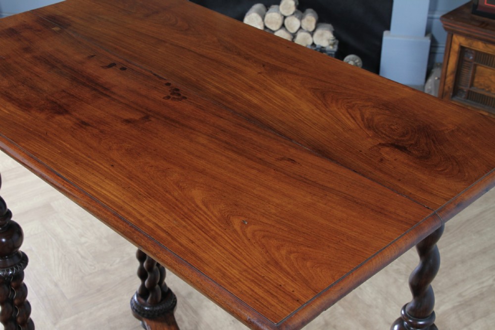 Victorian dark rosewood hall table featuring four triple barley twist legs connected by a central X-frame stretcher. View X