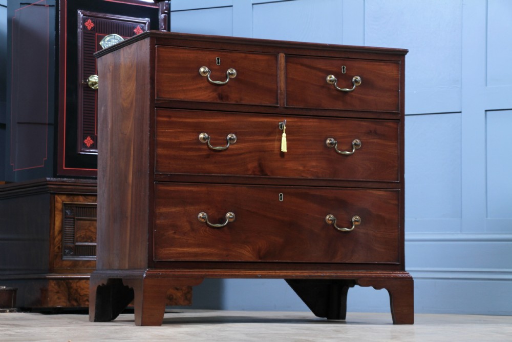An eighteenth-century Georgian mahogany chest of drawers featuring four drawers with brass swan-neck handles and bracket feet. View III