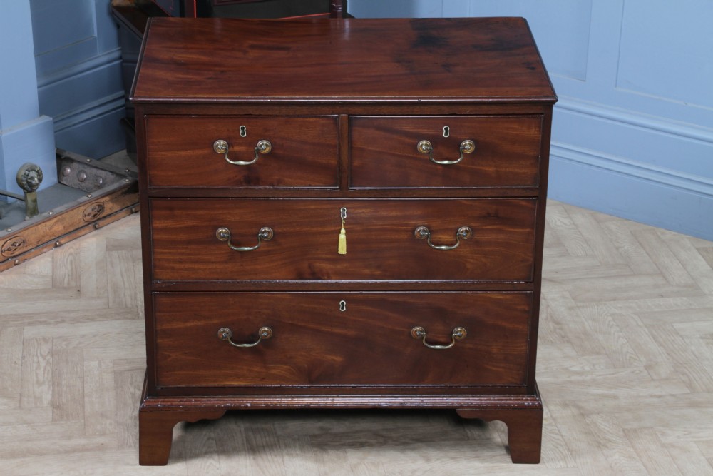An eighteenth-century Georgian mahogany chest of drawers featuring four drawers with brass swan-neck handles and bracket feet. View VII