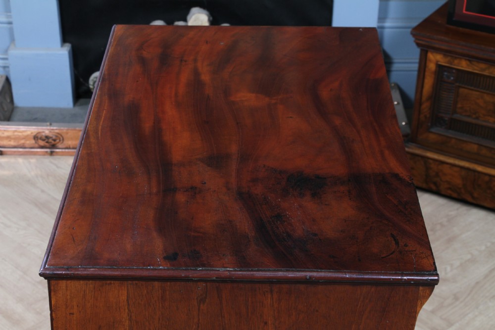 An eighteenth-century Georgian mahogany chest of drawers featuring four drawers with brass swan-neck handles and bracket feet. View IX