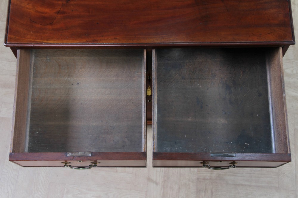An eighteenth-century Georgian mahogany chest of drawers featuring four drawers with brass swan-neck handles and bracket feet. View XIV