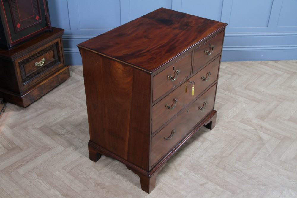 An eighteenth-century Georgian mahogany chest of drawers featuring four drawers with brass swan-neck handles and bracket feet. View XVII