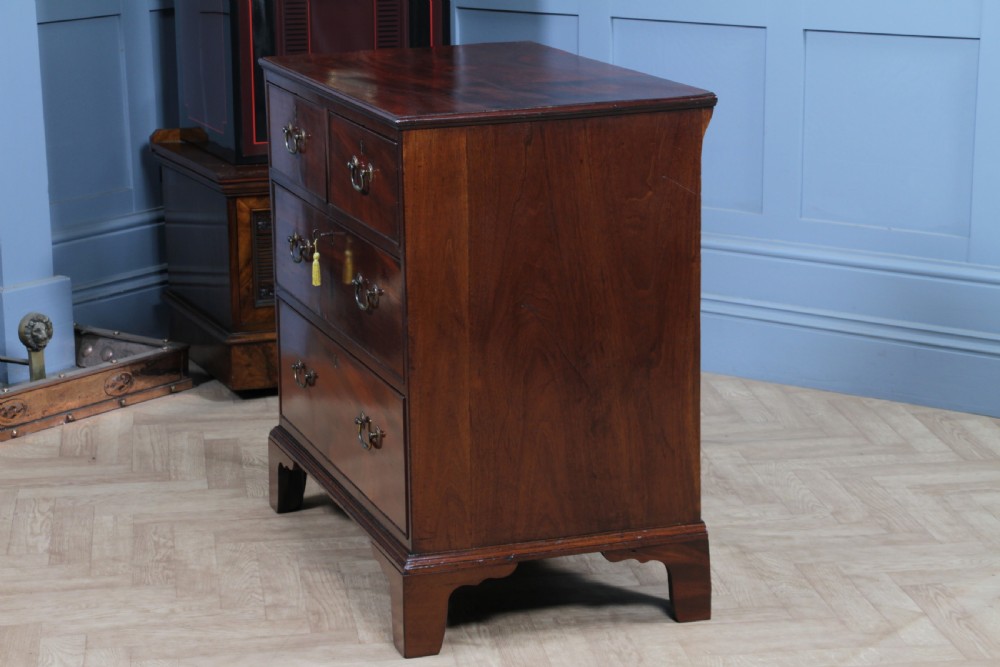 An eighteenth-century Georgian mahogany chest of drawers featuring four drawers with brass swan-neck handles and bracket feet. View XIX